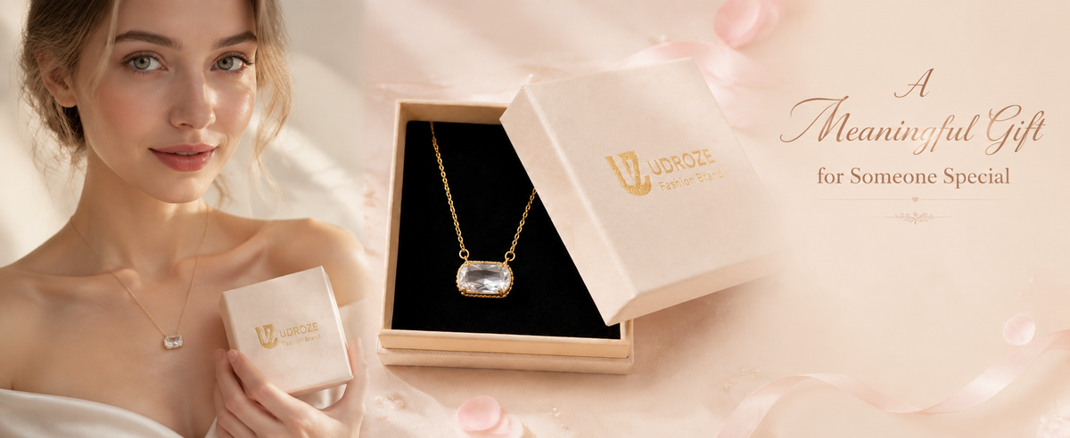 Clear rectangular pendant necklace shown worn and in its presentation box.